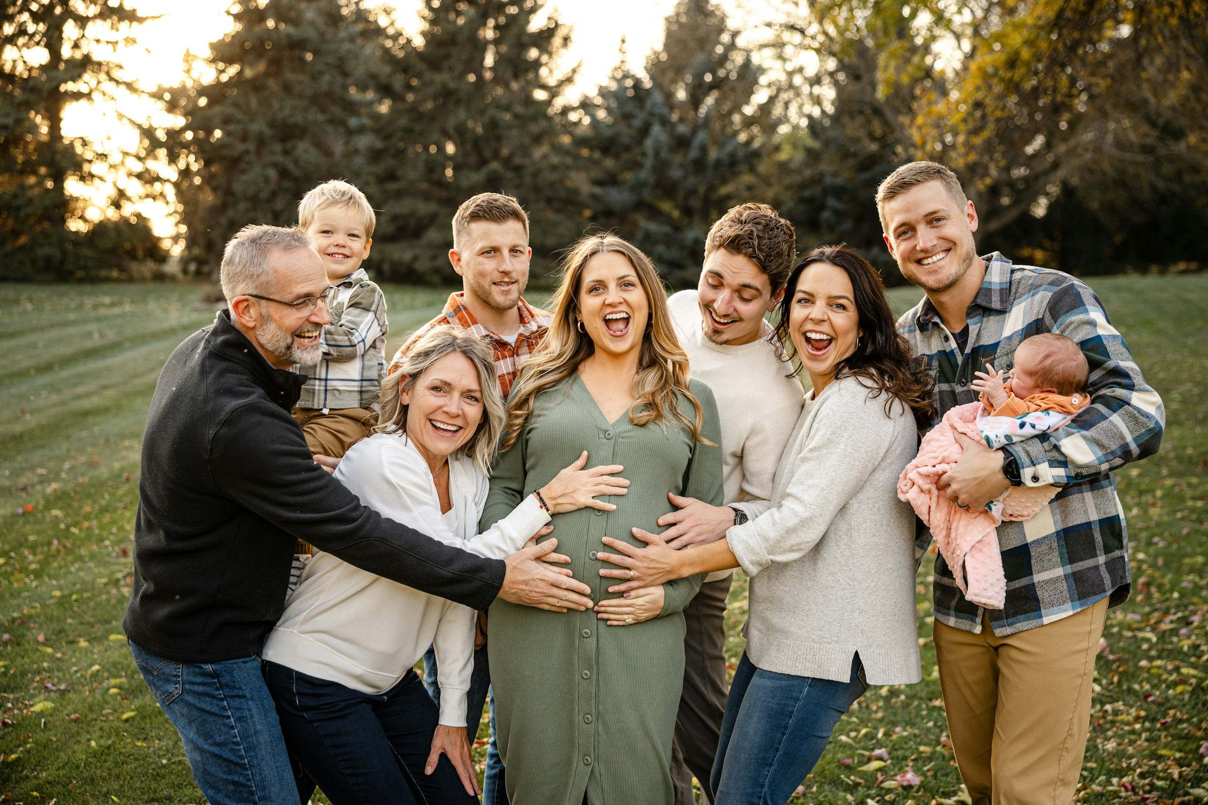 A large multigenerational family gathered together on a lawn in autumn