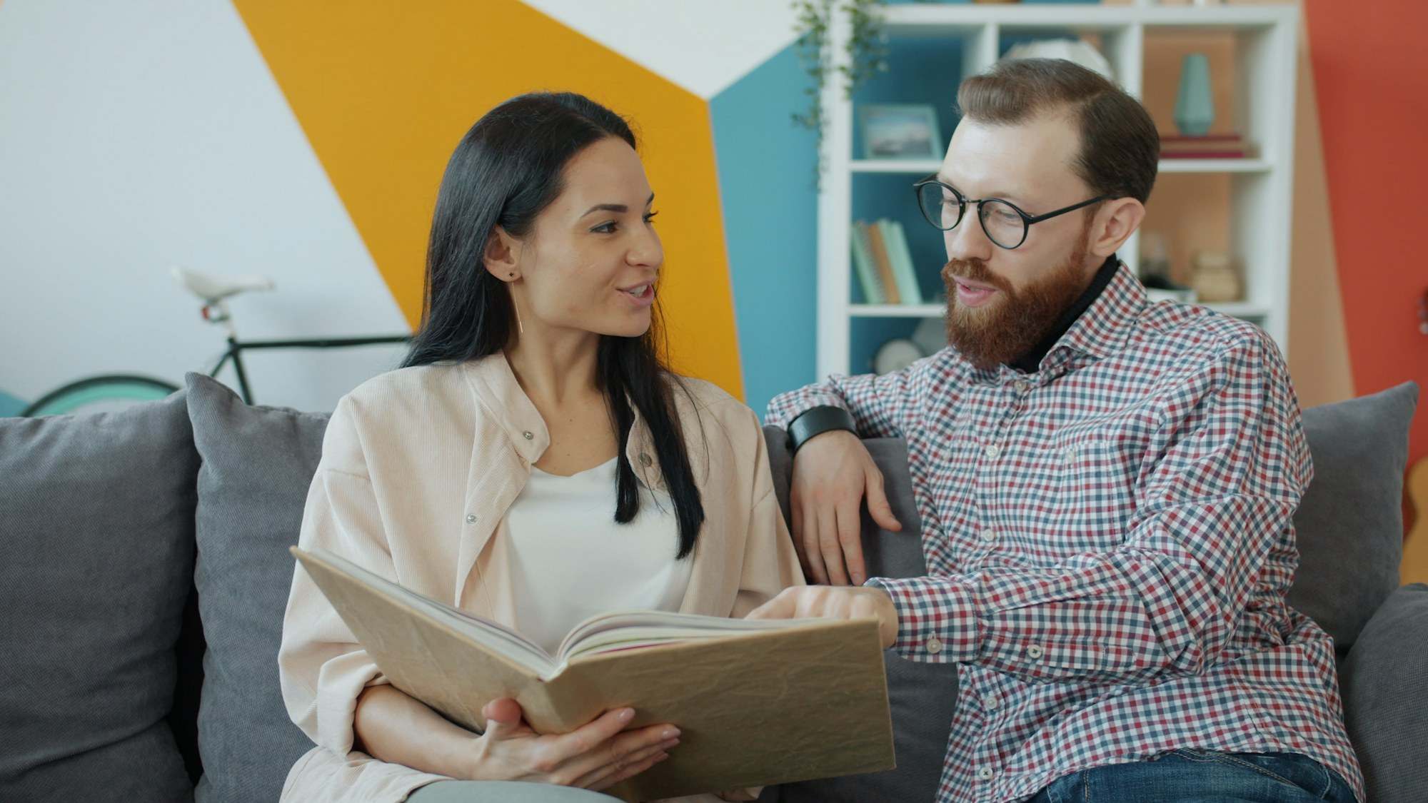 Couple looking through an open photo album together