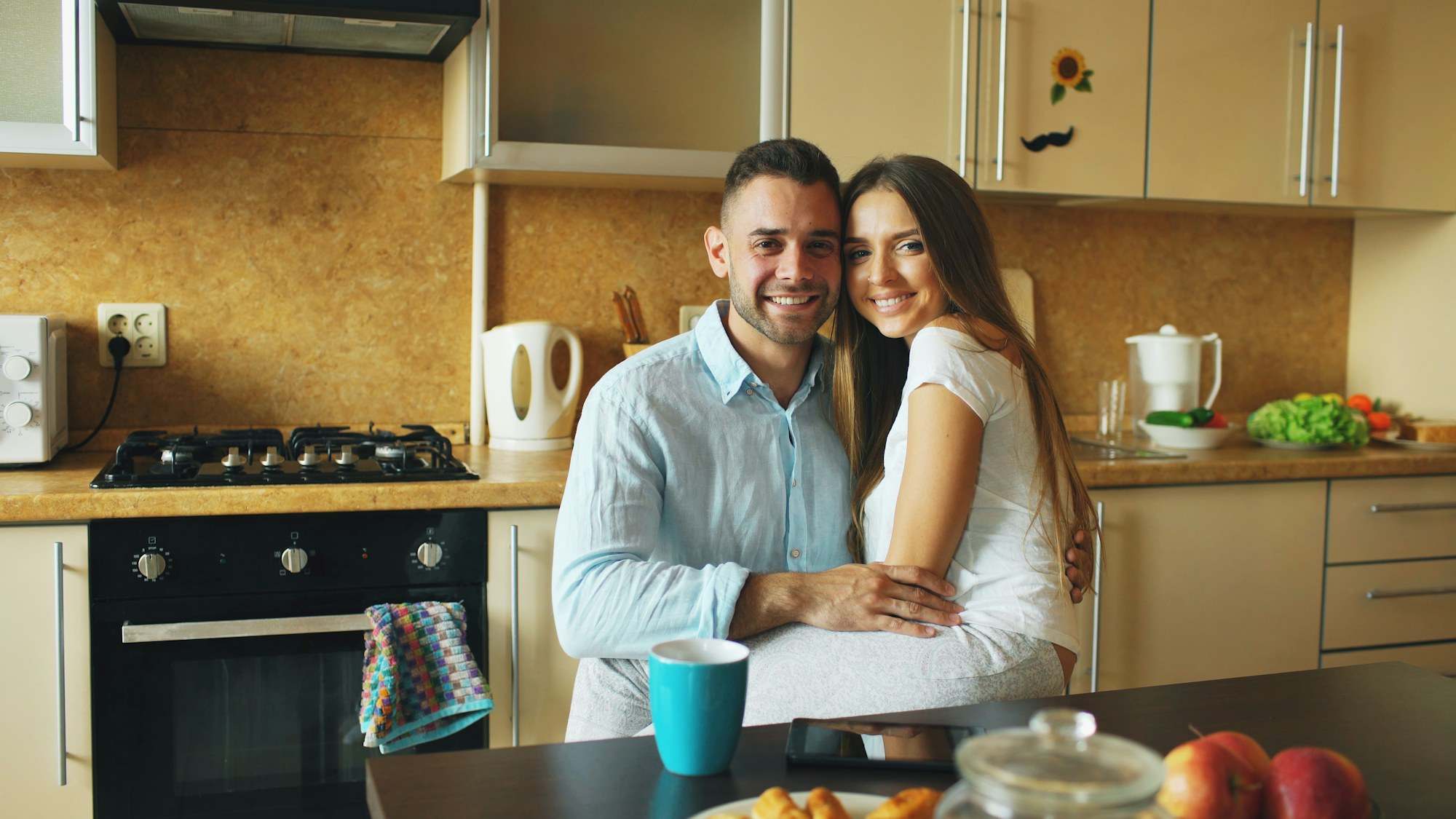 Couple smiling together in a modern kitchen